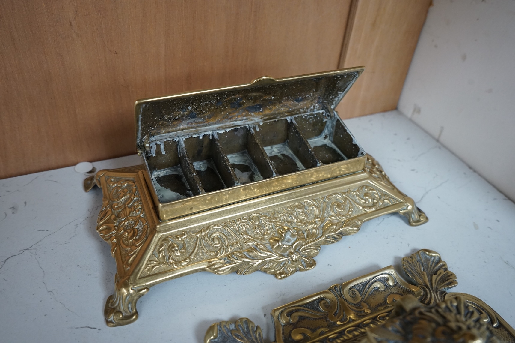 A decorative brass stamp box and a similar inkwell, largest 22cm wide